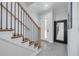 Elegant foyer featuring a staircase with wooden rails and stylish tile flooring at 4515 W North A St # 8, Tampa, FL 33609