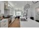 Modern kitchen features a quartz countertop island, stainless appliances, and an adjacent dining area at 4515 W North A St # 8, Tampa, FL 33609