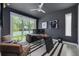 Well-lit home office featuring an executive desk, comfortable seating, and sliding glass doors to the outdoors at 4515 W North A St # 8, Tampa, FL 33609