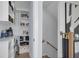 Walk-in pantry with custom shelving offers ample storage space adjacent to stairs at 4515 W North A St # 8, Tampa, FL 33609