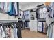 Spacious walk-in closet with custom shelving, drawers, and hanging rods for optimal organization at 4515 W North A St # 8, Tampa, FL 33609