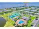 Aerial view of a resort featuring tennis courts, a pool, and waterfront homes at 5285 Coquina Key Se Dr # C, St Petersburg, FL 33705