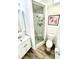 Elegant bathroom featuring a modern vanity, toilet, and a glass-enclosed shower with stylish tile work at 5285 Coquina Key Se Dr # C, St Petersburg, FL 33705
