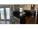 Modern kitchen features sleek cabinets, granite counters, and water view at 5285 Coquina Key Se Dr # C, St Petersburg, FL 33705