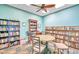 Cozy library with bookshelves, a ceiling fan, and a table with chairs at 5285 Coquina Key Se Dr # C, St Petersburg, FL 33705