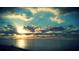 Breathtaking ocean scene with sun rays breaking through the clouds and calm waters at 5285 Coquina Key Se Dr # C, St Petersburg, FL 33705