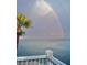 Relaxing water view featuring a rainbow and palm trees at 5285 Coquina Key Se Dr # C, St Petersburg, FL 33705