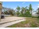 Expansive backyard featuring a concrete patio area and lush greenery at 5300 6Th S Ave, St Petersburg, FL 33707