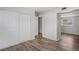 Bedroom with modern wood floors, a closet with sliding doors, and an open doorway at 5300 6Th S Ave, St Petersburg, FL 33707