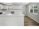 Bright kitchen with white cabinets, stainless steel appliances, and a breakfast bar countertop at 5300 6Th S Ave, St Petersburg, FL 33707