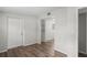Living area featuring wood-look floors, a front door, and a view into an adjoining room at 5300 6Th S Ave, St Petersburg, FL 33707