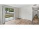 Bright living room featuring a sliding glass door with outdoor views and modern light wood floors at 5300 6Th S Ave, St Petersburg, FL 33707