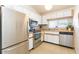 Well-equipped kitchen with stainless steel appliances, white cabinets, and functional layout, designed for efficiency at 5419 Marlwood Ct, Tampa, FL 33624