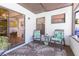 Enclosed patio features two chairs and a sliding glass door to the home at 5419 Marlwood Ct, Tampa, FL 33624