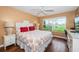 Comfortable bedroom with a queen bed, bright light from the window, and a desk area at 6073 Bahia Del Mar Blvd # 129, St Petersburg, FL 33715