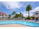 Inviting community pool area with lounge chairs and lush tropical landscaping at 6073 Bahia Del Mar Blvd # 129, St Petersburg, FL 33715