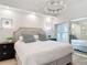 Bright bedroom featuring a crystal chandelier and a king-sized bed with plush pillows at 700 S Harbour Island Blvd # 143, Tampa, FL 33602