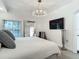 Cozy bedroom with a crystal chandelier, large mirror, and a mounted television at 700 S Harbour Island Blvd # 143, Tampa, FL 33602