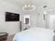 Bedroom with modern decor, including a large television and a crystal chandelier at 700 S Harbour Island Blvd # 143, Tampa, FL 33602