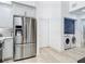 Contemporary kitchen with stainless steel appliances, white cabinetry, and adjacent laundry area at 700 S Harbour Island Blvd # 143, Tampa, FL 33602