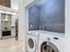 Laundry room area with tile accent wall and Samsung washer/dryer near a kitchen with stainless steel appliances at 700 S Harbour Island Blvd # 143, Tampa, FL 33602