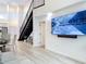 Modern living space with high ceilings, staircase, and large TV, creating a sophisticated ambiance at 700 S Harbour Island Blvd # 143, Tampa, FL 33602
