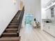 Open-concept living space with wood-look floors, grand staircase, and high ceilings at 700 S Harbour Island Blvd # 143, Tampa, FL 33602