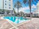 Community pool with blue water, palm trees, and a water feature at 700 S Harbour Island Blvd # 143, Tampa, FL 33602