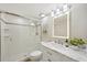 Updated bathroom with glass-enclosed shower and a vanity with a lighted mirror at 7564 Bayshore Dr # 306, Treasure Island, FL 33706