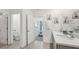 Well-appointed bathroom featuring a double sink vanity and access to the Primary bedroom at 7770 Wheat Stone Dr, Zephyrhills, FL 33540