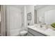 Well-lit bathroom featuring a shower/tub combo, single sink vanity, and neutral decor at 7770 Wheat Stone Dr, Zephyrhills, FL 33540