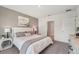 Bedroom with a neutral color scheme, a comfortable bed, and a view of the bathroom at 7770 Wheat Stone Dr, Zephyrhills, FL 33540