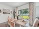Elegant dining area with a view of the backyard and stylish decor at 7770 Wheat Stone Dr, Zephyrhills, FL 33540