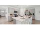Bright kitchen with a center island, stainless steel appliances, and bar stool seating at 7770 Wheat Stone Dr, Zephyrhills, FL 33540