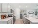 Modern kitchen features stainless steel appliances, white countertops, and ample cabinet space at 7770 Wheat Stone Dr, Zephyrhills, FL 33540