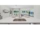 Open-concept kitchen and living space with stainless steel appliances and backyard views at 7770 Wheat Stone Dr, Zephyrhills, FL 33540