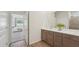 Primary bathroom vanity, featuring a double sink and open doorway to the main bedroom space at 7775 Wheat Stone Dr, Zephyrhills, FL 33540