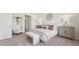 Spacious bedroom with paneled accent wall, neutral color scheme and modern furnishings for a relaxed feel at 7775 Wheat Stone Dr, Zephyrhills, FL 33540