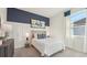 Stylish bedroom featuring a navy accent wall, paneling, and a comfortable bed with decorative pillows at 7775 Wheat Stone Dr, Zephyrhills, FL 33540