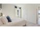 Bright bedroom features a walk in closet, neutral walls, carpet and a light wood door at 7775 Wheat Stone Dr, Zephyrhills, FL 33540