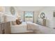 Serene bedroom with natural light, paneled wall, decorative accents, and neutral color scheme at 7775 Wheat Stone Dr, Zephyrhills, FL 33540