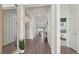 Bright entryway boasts wood flooring, accent walls and a glimpse into the open living space at 7775 Wheat Stone Dr, Zephyrhills, FL 33540