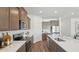 Bright kitchen featuring stainless appliances, a large island, and sleek countertops at 7775 Wheat Stone Dr, Zephyrhills, FL 33540