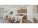 Stylish kitchen with stainless appliances, island seating, and an adjacent dining area at 7775 Wheat Stone Dr, Zephyrhills, FL 33540