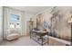 Bright home office featuring a modern desk, decorative wallpaper, comfortable seating and ample natural light at 7775 Wheat Stone Dr, Zephyrhills, FL 33540