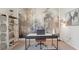 Stylish home office features an industrial desk, decorative wallpaper, a trendy light fixture and modern shelving at 7775 Wheat Stone Dr, Zephyrhills, FL 33540