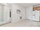 Kitchen area with tile flooring and white appliances, adjacent to the hallway at 7903 Seminole Blvd # 2204, Seminole, FL 33772