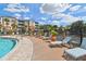 Relaxing poolside lounge area featuring deck chairs and community lake views at 7903 Seminole Blvd # 2204, Seminole, FL 33772