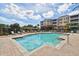 Beautiful community pool area with ample deck space, landscaping and nearby pergola at 7903 Seminole Blvd # 2204, Seminole, FL 33772