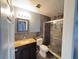 Modern bathroom with a stylish glass-enclosed shower, granite sink, and decorative mosaic mirror at 804 Whitehurst Rd, Plant City, FL 33563